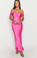 Model in an elegant hot pink formal dress. This beautiful prom gown features a draped, off-the-shoulder neckline and a sleek, floor-length silhouette.