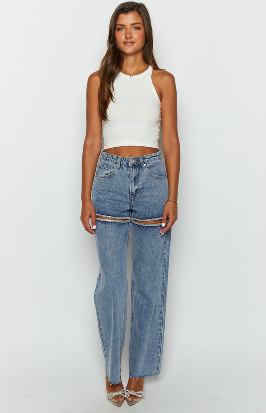 blue denim jeans with thighs slits lined with diamantes on brunette model 
