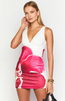 blonde girl wearing a white mini dress with an oversized red and pink orchid floral print