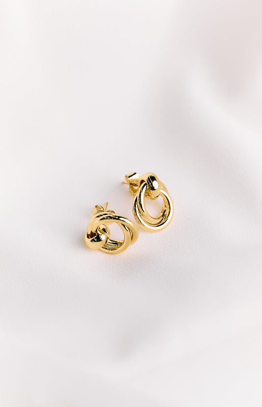 A pair of gold-plated, chunky hoop earrings with a push-back closure, displayed on a white background.