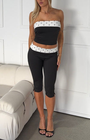 Beginning Boutique Reece Black Polka Dot Band Capris black fitted capris with white polka dot waistband and small side slits