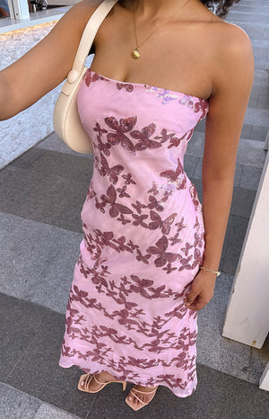 Girl wearing pink sequin maxi dress and nude heels with a nude handbag.